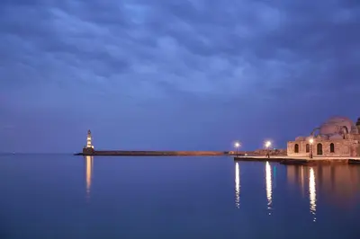 a lighthouse in the middle of a body of water at Domus Renier Boutique Hotel in Chania Town