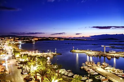 a harbor at night with boats in the water at Stam's Paradise in Chania Town