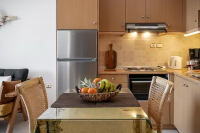 a kitchen with a table with a bowl of fruit on it at Stam's Paradise in Chania Town