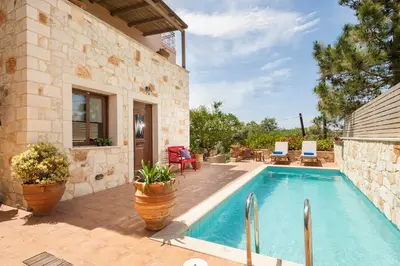 a house with a swimming pool and a patio at My Villa Dafni in Stalos