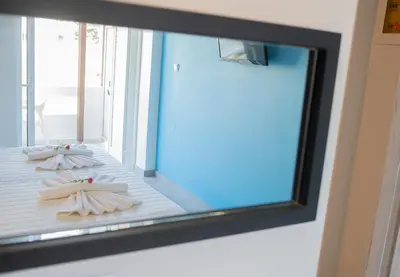 a mirror in a room with towels on the floor at Niriides in Almirida