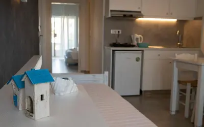 a kitchen with a table with a toy house on it at Niriides in Almirida