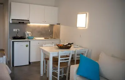 a small kitchen with a table and a counter top at Niriides in Almirida