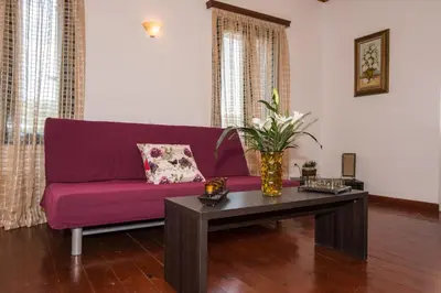 a living room with a purple couch and a coffee table at Dekem Residence in Gavalochori