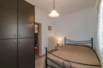 a bedroom with a bed and a dresser in a room at Dekem Residence in Gavalochori