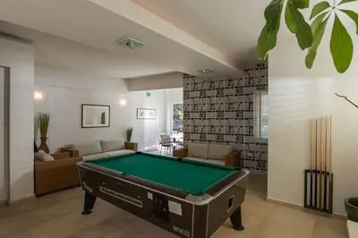 a living room with a pool table at Corinna Mare in Kalamaki Chanion
