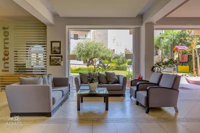 a living room with couches and a table at Corinna Mare in Kalamaki Chanion