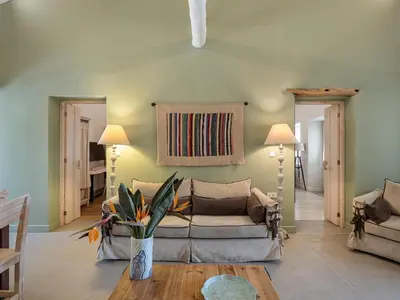 a living room with a couch and a table at Geraniotis Villa in Gerani Chanion