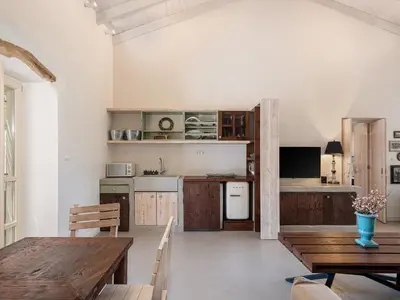 a kitchen with a table and a dining room at Geraniotis Villa in Gerani Chanion