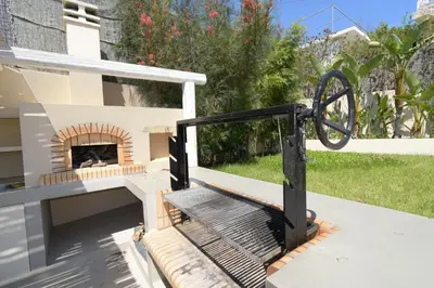 a patio with a fireplace on a house at Geraniotis Villa in Gerani Chanion