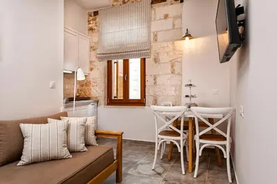 a living room with a couch and a table at Casa di Gouto in Chania Town