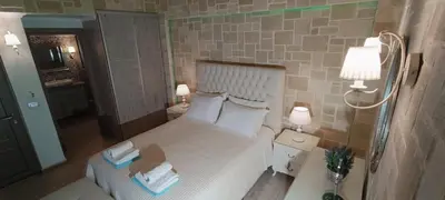 a small bedroom with a bed and two lamps at Villa Alexandros in Kissamos