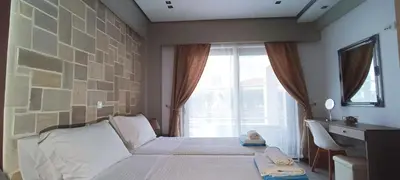 a bedroom with a bed with a large window at Villa Alexandros in Kissamos