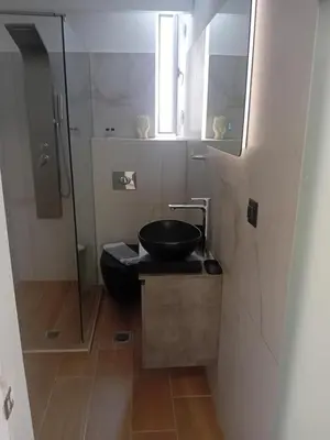 a bathroom with a sink and a glass shower at Sotoportego in Chania Town