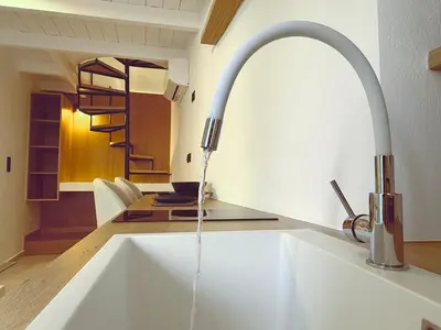 a kitchen sink with water coming from a faucet at Sotoportego in Chania Town