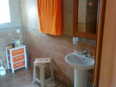 a bathroom with a sink and a stool in it at Hostel Stylianos Kissamos in Kissamos