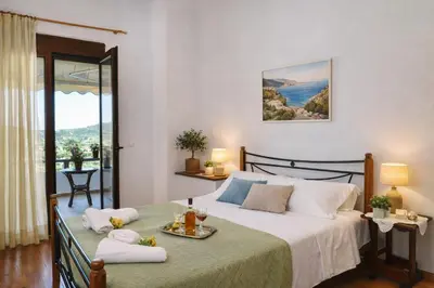 a bedroom with a large bed with towels on it at Melli House in Melissouryíon