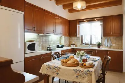 a kitchen with a table with a basket of food on it at Melli House in Melissouryíon