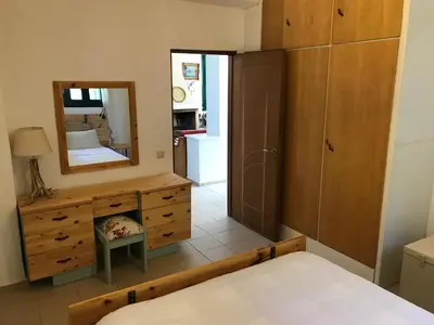 a bedroom with a bed and a mirror and a dresser at Temenia House in Teménia