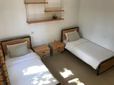 two beds in a small room withermottermott at Temenia House in Teménia