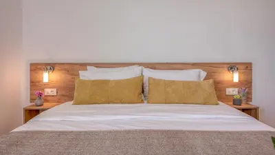 a bedroom with a large bed with two night stands at Kaliviani Traditional Hotel in Kissamos