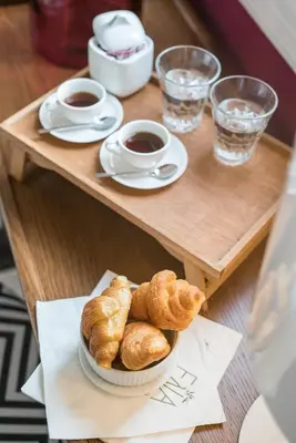a table with a plate of pastries and cups of coffee at Elia Portou Due in Chania Town