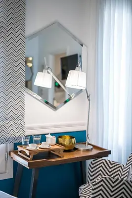 a table with two lamps and a mirror on a wall at Elia Portou Due in Chania Town