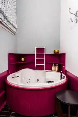 a hot pink bath tub in a bathroom with a ladder at Elia Portou Due in Chania Town
