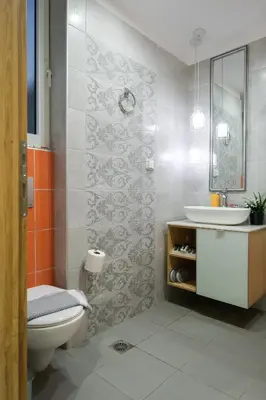 a bathroom with a white toilet and a sink at Arocaria Apartments in Chania Town