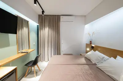 a hotel room with a bed and a desk at Arocaria Apartments in Chania Town