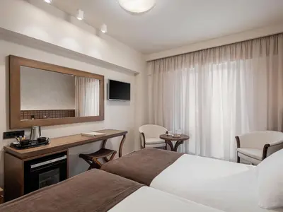 a hotel room with a bed and a desk at Civitel Akali Hotel in Chania Town