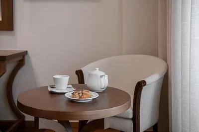 a table with a tea pot and a plate of food at Civitel Akali Hotel in Chania Town