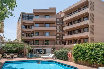 an apartment building with a swimming pool in front of it at Civitel Akali Hotel in Chania Town