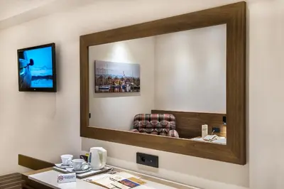 a mirror on the wall of a hotel room at Civitel Akali Hotel in Chania Town