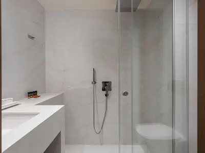 a bathroom with a shower with a toilet and a sink at Civitel Akali Hotel in Chania Town