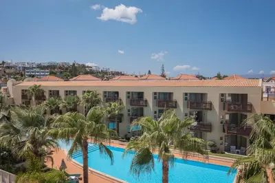 an aerial view of the resort with palm trees and a swimming pool at Giannoulis - Santa Marina Plaza (Adults Only) in Agia Marina Nea Kydonias