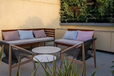two chairs and a table with pillows on a patio at San Salvatore Monastery in Chania Town