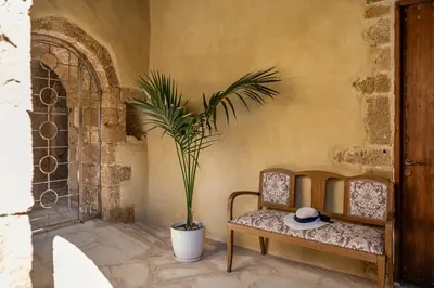 a room with a bench and a plant in it at San Salvatore Monastery in Chania Town