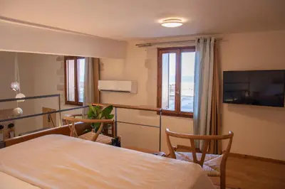 a room with a table and chairs and a television at San Salvatore Monastery in Chania Town
