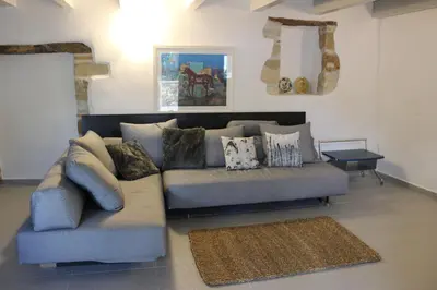 a living room with a couch and a table at Chorio House Platanias in Vrísai