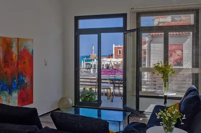 a living room with a view of a city at Faro Apartments in Chania Town