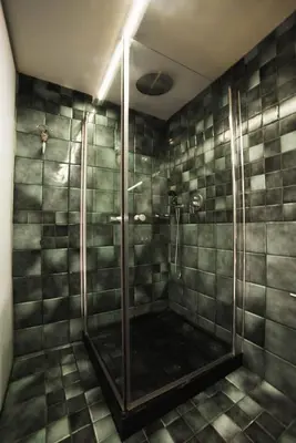 a bathroom with a shower with a glass door at Faro Apartments in Chania Town