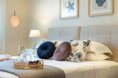 a room with a couch with pillows and a table at Villa Ampelaki - Premium Villa with heated pool in Kounoupidhianá
