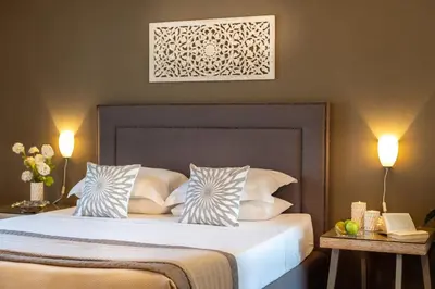 a bedroom with a large bed with two pillows at Villa Ampelaki - Premium Villa with heated pool in Kounoupidhianá
