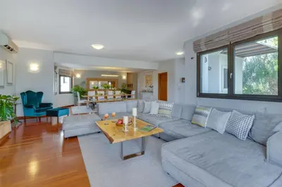 a living room with a couch and a table at Villa Ampelaki - Premium Villa with heated pool in Kounoupidhianá