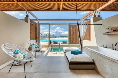 a room with a hammock and a swimming pool at Domes Noruz Chania, Autograph Collection- Adults Only in Kato Daratso