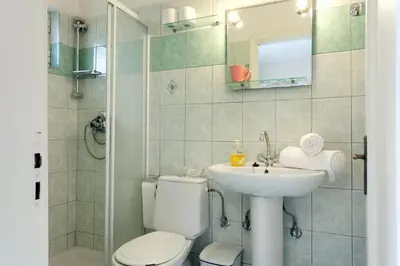 a bathroom with a toilet and a sink at Agapi Studios in Kato Daratso
