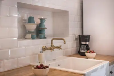 a white kitchen with a sink and a mixer at Casa Regina Luxury House in Chania Town