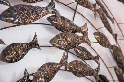 a group of bronze fish on a white plate at Casa Regina Luxury House in Chania Town