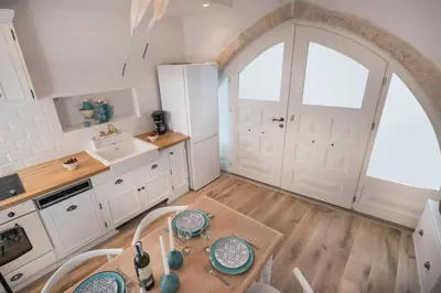 a kitchen with a table and a large window at Casa Regina Luxury House in Chania Town